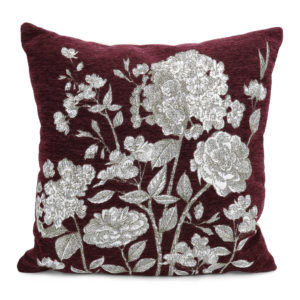 Burgundy pillow with white floral stitching.