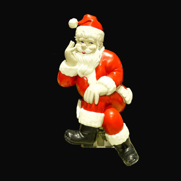 Large Santa statue sitting on present cross-legged.