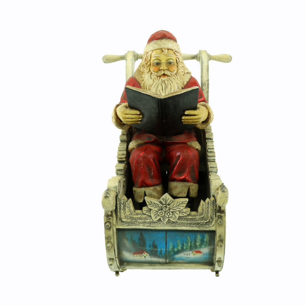Large Santa in Sleigh. Santa is leaning back ready a book saying "T'was the night before Christmas....".