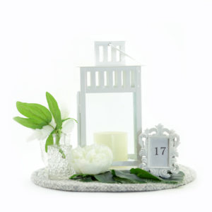 White lantern and floral centrepiece.