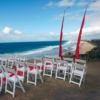 Fold-out white Americana chairs. These crisp white chairs with a padded seat are the go-to chair for weddings and events. They suit indoor and outdoor events and are foldable and stackable for ease of use.