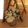 Faux white florals in wicker basket.
