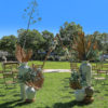 If you're dreaming of a romantic, free-spirited, bohemian style Wedding, then this ceremony package is for you! 
With a breathtaking triangle timber arbour adorned with captivating florals, your guests will be transported to a magical place as they witness you sharing your special Wedding vows.

Package price includes set up and pack down.

NOTE: Package price includes faux floral arrangement on the timber arbour and in the large white pots. 
We are also able to provide fresh florals on the timber arbour as an alternative upgrade.